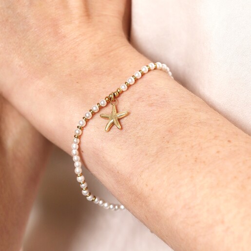 Close Up of Model Close Up of Stainless Steel Beaded Pearl Starfish Pendant Bracelet in Gold on Model