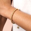 Close Up of Stainless Steel Bubble Ball Bracelet in Gold on Model