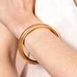 Close Up of Stainless Steel Chunky Bangle in Gold on Model