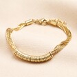 Featuring multiple connected strands of gold chain, this bracelet has numerous ring charms.