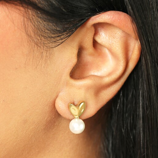 Close up of earrings on model Gold Heart and Pearl Earrings on a model