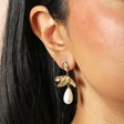 Gold Leaf and Pearl Drop Earrings on a model