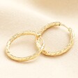 With a hammered touch, this waterproof pair of hoop earrings is made of gold plated stainless steel