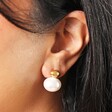 Close Up ofStainless Steel Large Pearl Drop Earrings in Gold on Model