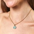 Close Up of Semi-Precious Amazonite Pendant Necklace in Gold on Model