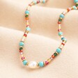 A multicoloured necklace with a freshwater pearl