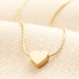 Stainless Steel Mini Heart Pendant Necklace in Gold on a neutral background