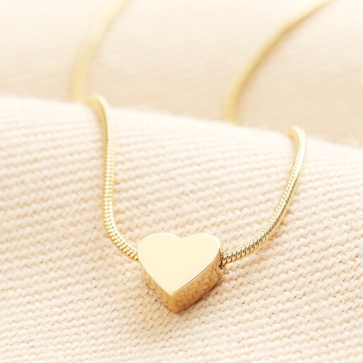 Stainless Steel Mini Heart Pendant Necklace in Gold on a neutral background