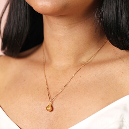 Close Up Model Shot Stainless Steel Wide Teardrop Necklace in Gold close up on a model