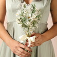 A bouquet of light white and pastel-dried flowers