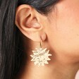 Close Up of Hammered Sun Drop Earrings in Goldon Model