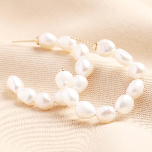 Oversized Freshwater Pearl Hoop Earrings on beige material background