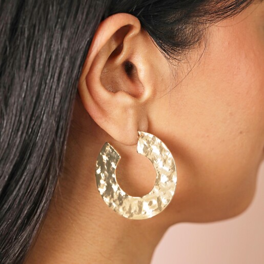 Oversized Hammered Flat Hoop Earrings in Gold on model