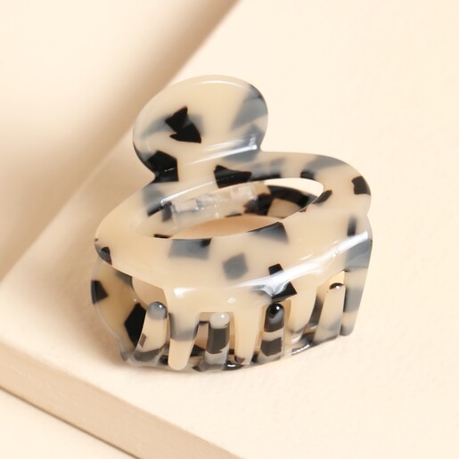 Oval Tortoiseshell Hair Claw on neutral background