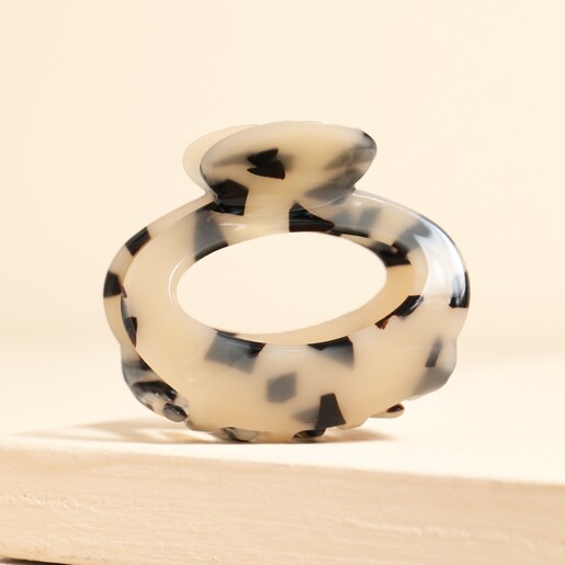 Oval Tortoiseshell Hair Claw on neutral background