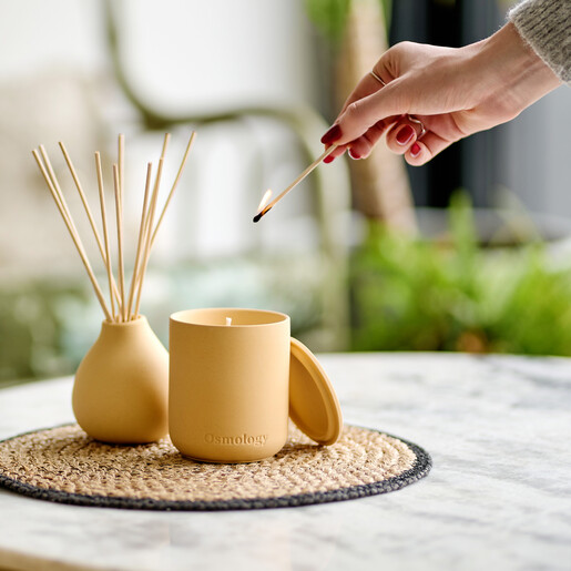 vanilla candle housed in a clay pot