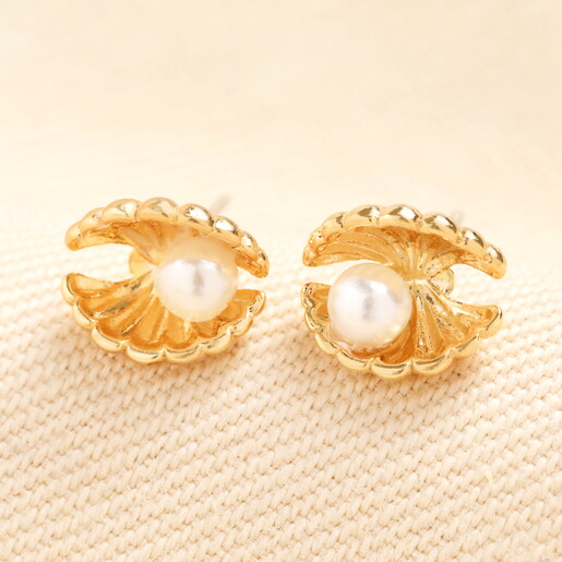 A Tiny Pair of Shell-Shaped Stud Earrings in Gold With Textured Details and Tiny Pearls