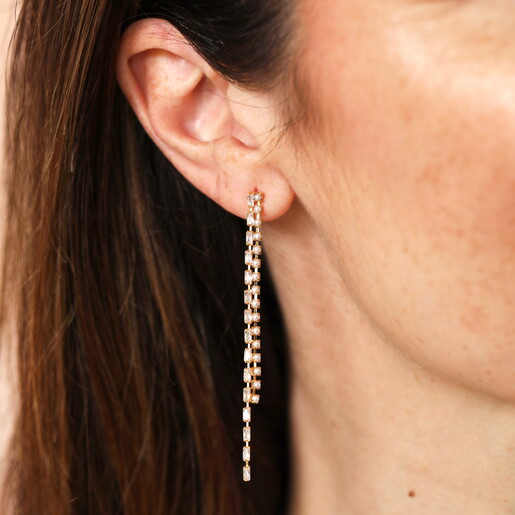 Model Wearing Dangly Crystal and Pearl Adorned Drop Earrings in Gold