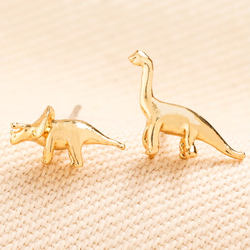 two examples of dino studs in gold