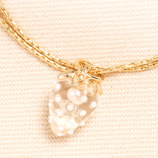 close up of glass strawberry charm in gold
