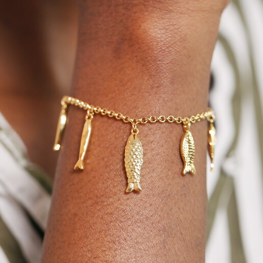 A Gold Curb Chain Bracelet with Dangling Fish Shaped Charms