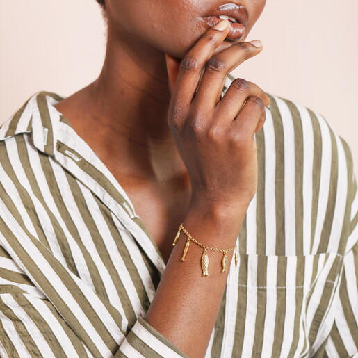 A Gold Curb Chain Bracelet with Dangling Fish Shaped Charms