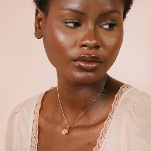 Close Up of Semi Precious Stone Pendant and Sun Shaped Gold Pendant on Satellite Chain Necklace