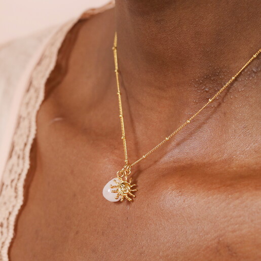 Close Up of Semi Precious Stone Pendant and Sun Shaped Gold Pendant on Satellite Chain Necklace