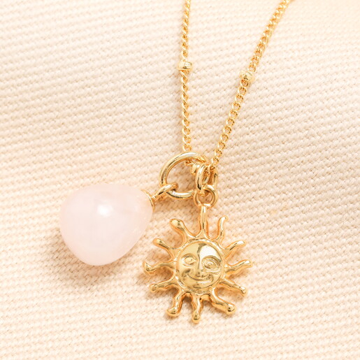 Close Up of Semi Precious Stone Pendant and Sun Shaped Gold Pendant on Satellite Chain Necklace