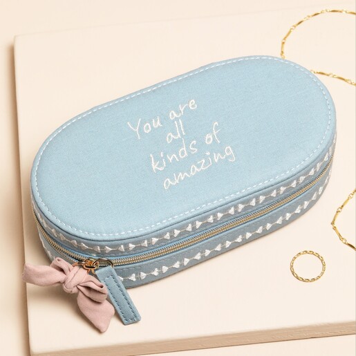 A Rounded Blue Fabric Case with a Meaningful Message Embroidered