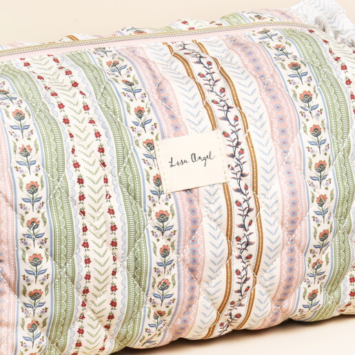 close up of Lisa Angel logo against quilted fabric