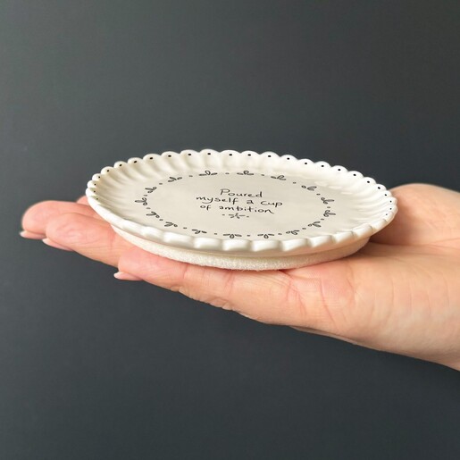 white ceramic coaster with scalloped edge