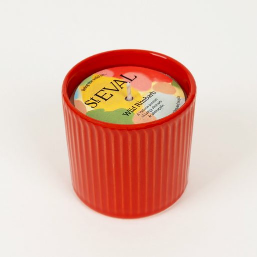 candle housed in a ceramic pot