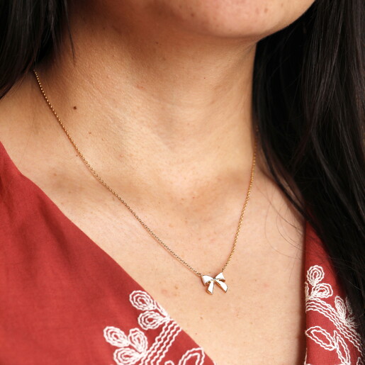 Enamel White Bow Pendant Necklace in Gold Close Up On Model