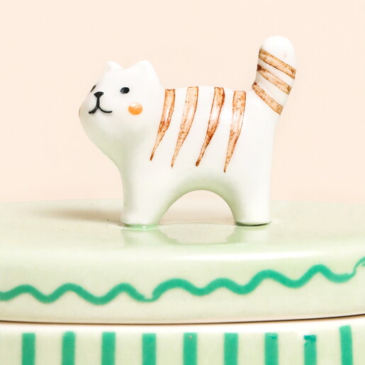 close up of cat figurine in white and brown