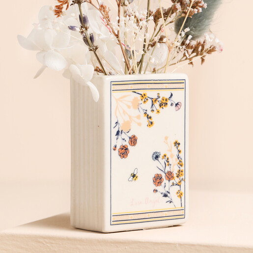 Back of Cream Ceramic Book Shaped Vase Filled With Flowers