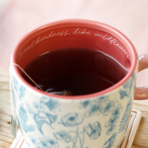 close up of floral mug with text