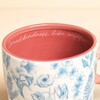 close up of floral mug with text