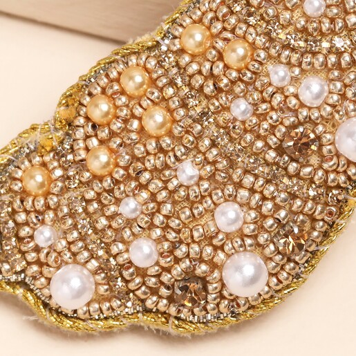 close up of gold beaded design