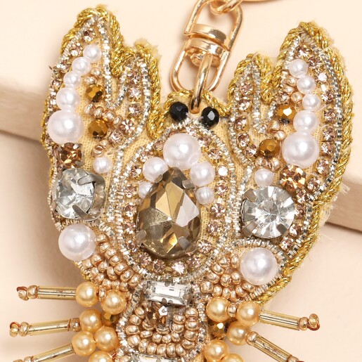 close up of beaded accessory in gold