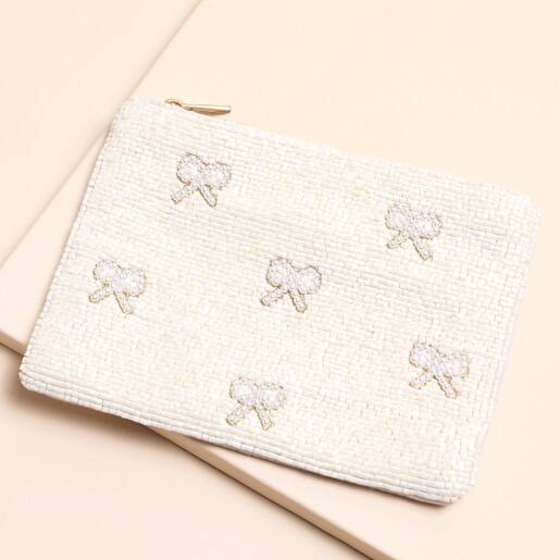 A White Beaded Pouch Decorated With Pearl Beaded Bows and a Beaded Tassel Zipper