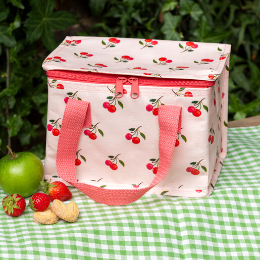 lunch box with pale pink background and cherry design