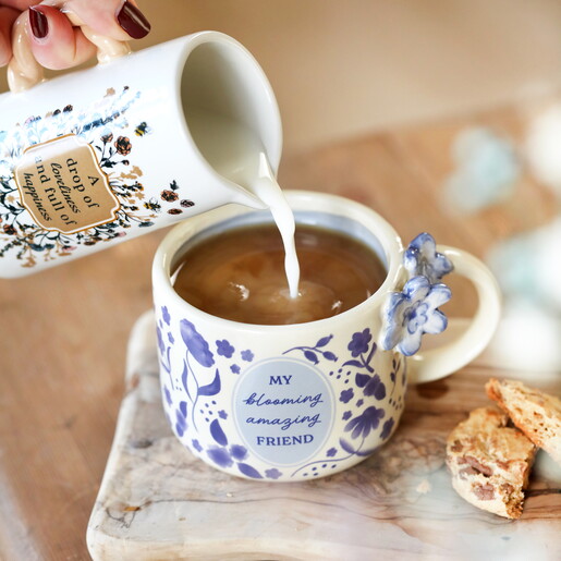 A Cream Ceramic Mug With a Blue Floral Print and a Meaningful Message About Friendship on the Front