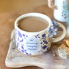 A Cream Ceramic Mug With a Blue Floral Print and a Meaningful Message About Friendship on the Front