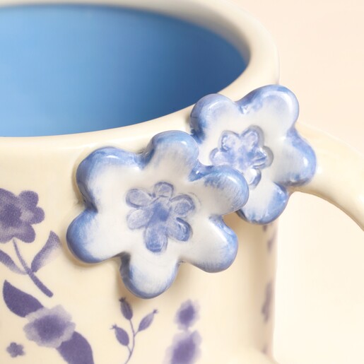 A Close Up of the Blue 3D Flower Figurines on the Handle of the Mug