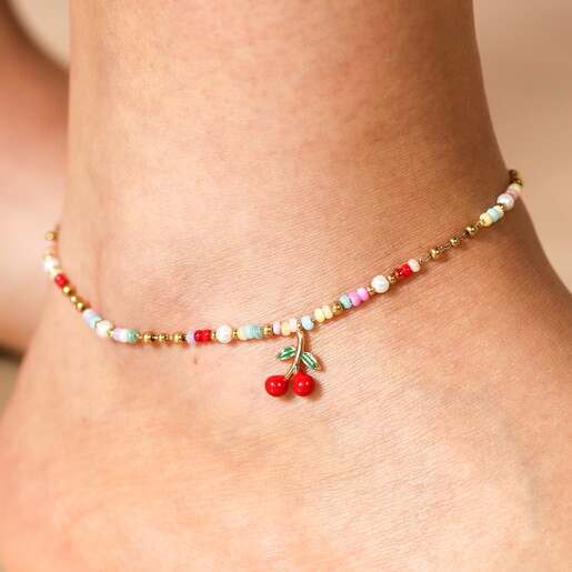 Close Up of a Bright Coloured Beaded Chain Anklet with a Cherry Charm Worn by Model