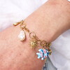 chunky charms bracelet in gold close up on model