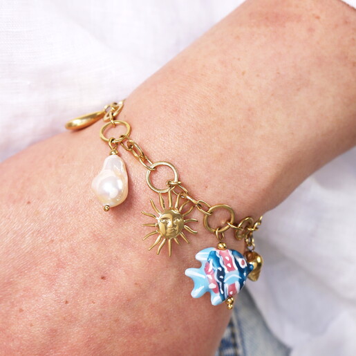 chunky charms bracelet in gold close up on model