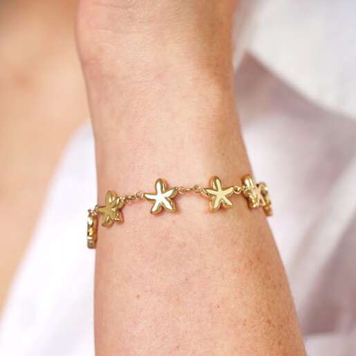 starfish chain bracelet in gold close up on model