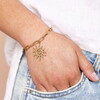gold celestial bracelet on model wrist